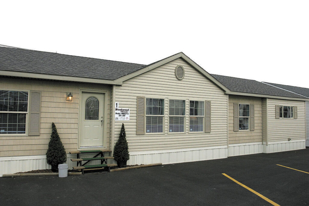 Modern manufactured home with vinyl siding and landscaped exterior