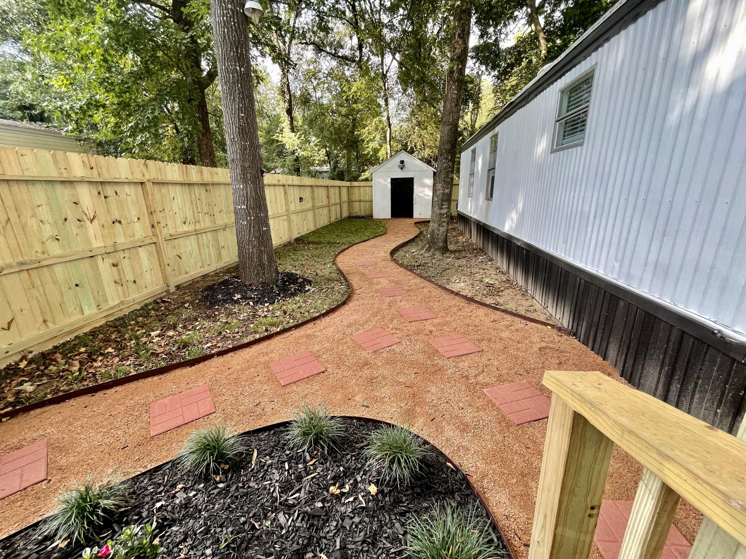 Exterior side view with mature trees and walkway