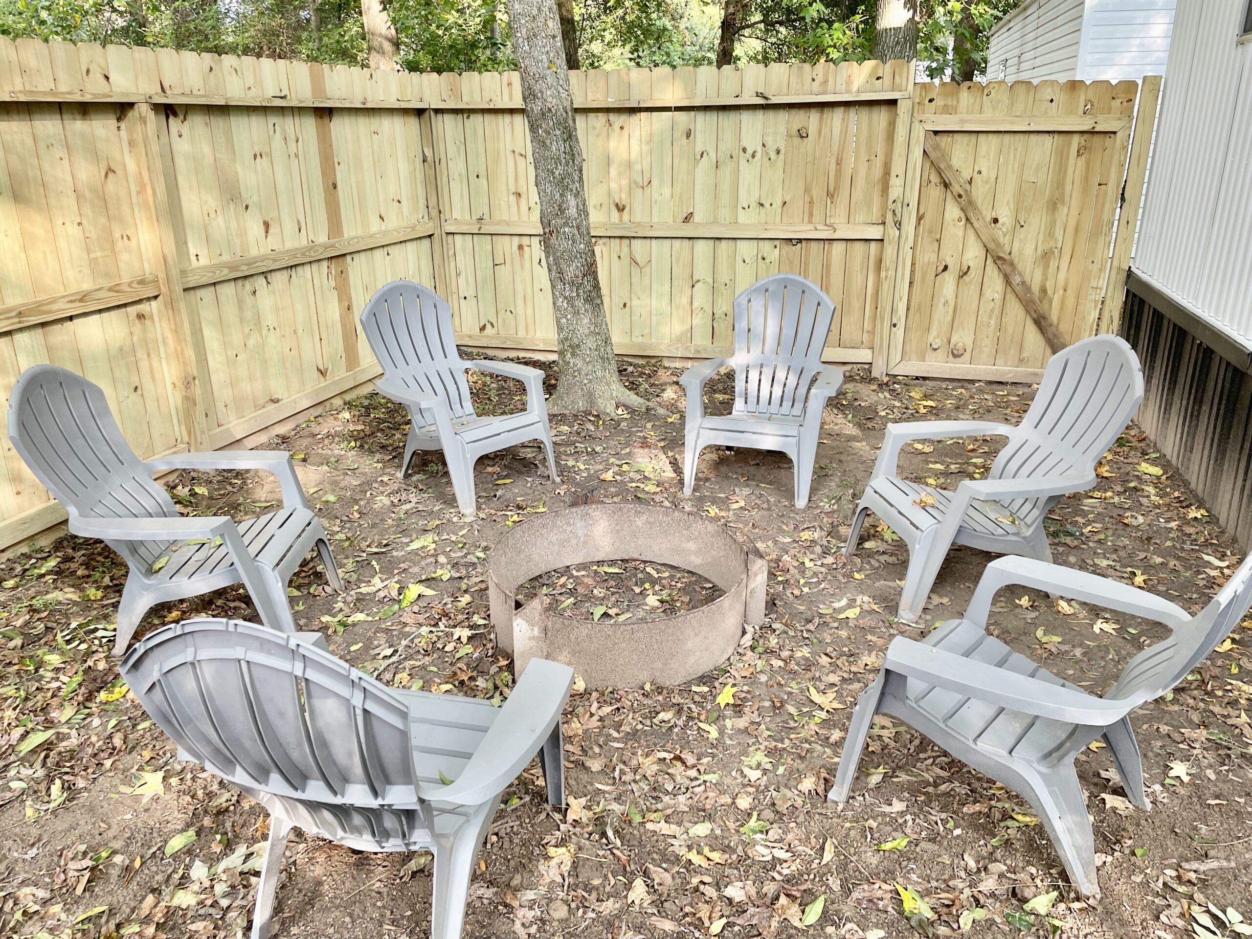 Backyard with fire pit and Adirondack chairs