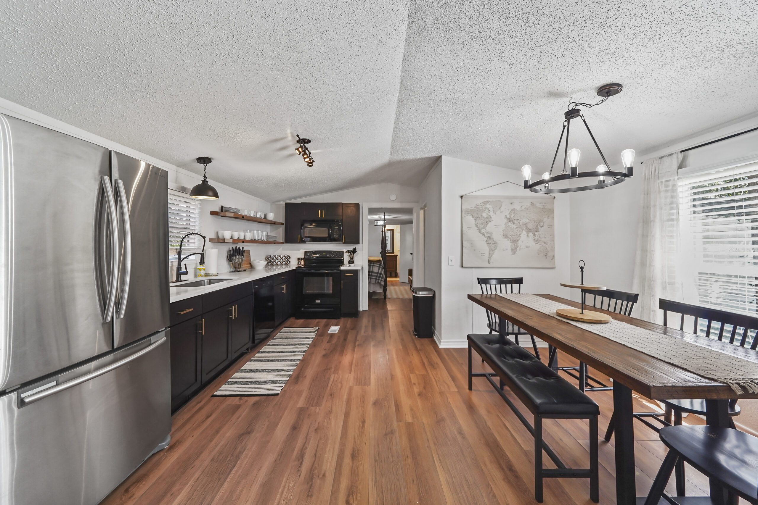 Renovated kitchen with quartz counters and dining area