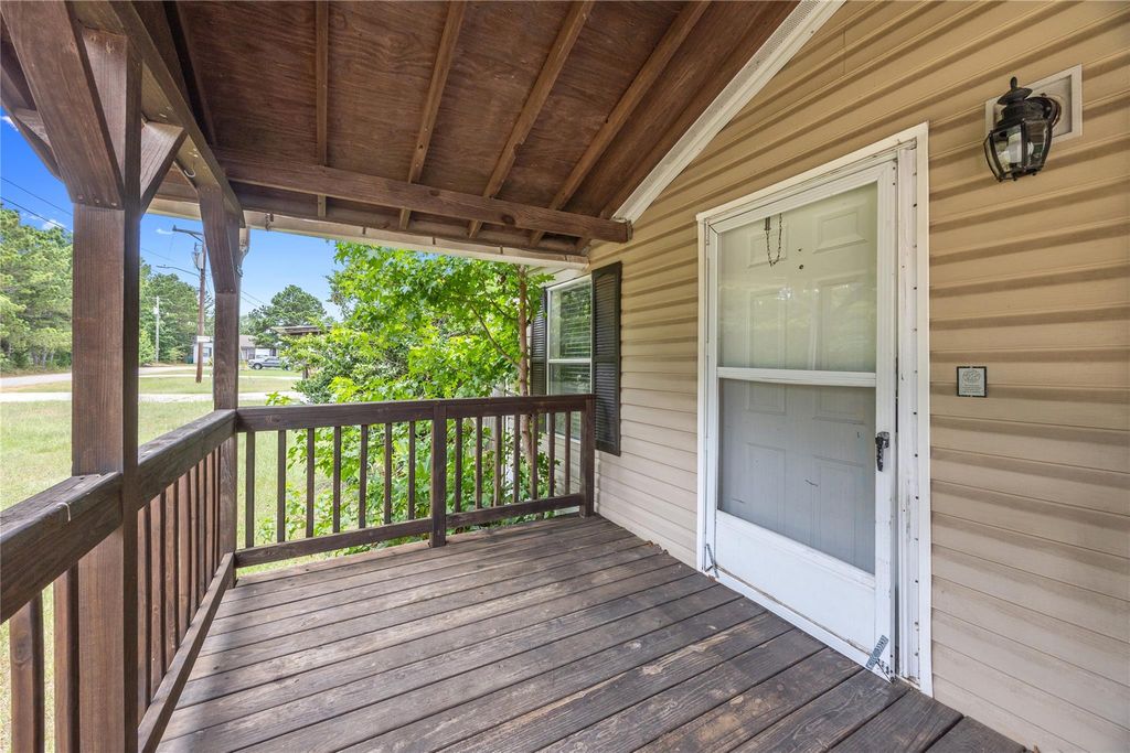 Covered front porch of this Willis TX home for sale on its own lot