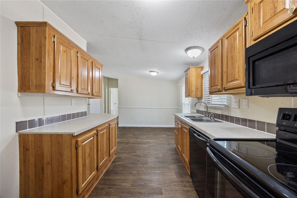 Kitchen with electric range and microwave