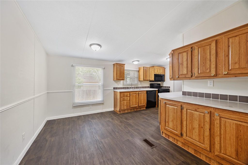Kitchen with wood cabinetry and generous counter space