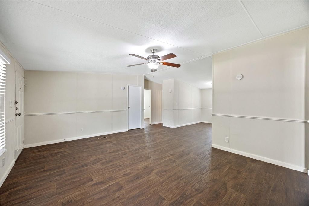 Bright open living room with ceiling fan