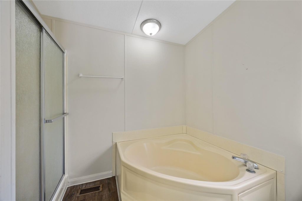 Primary bath featuring a corner soaking tub