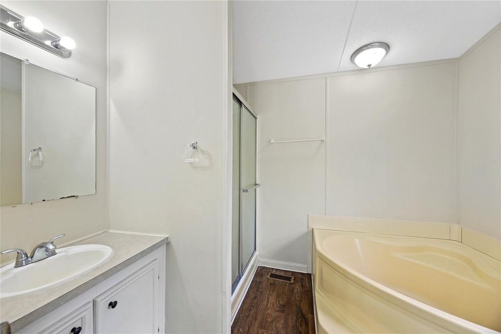 Primary bathroom with vanity, separate shower and soaking tub