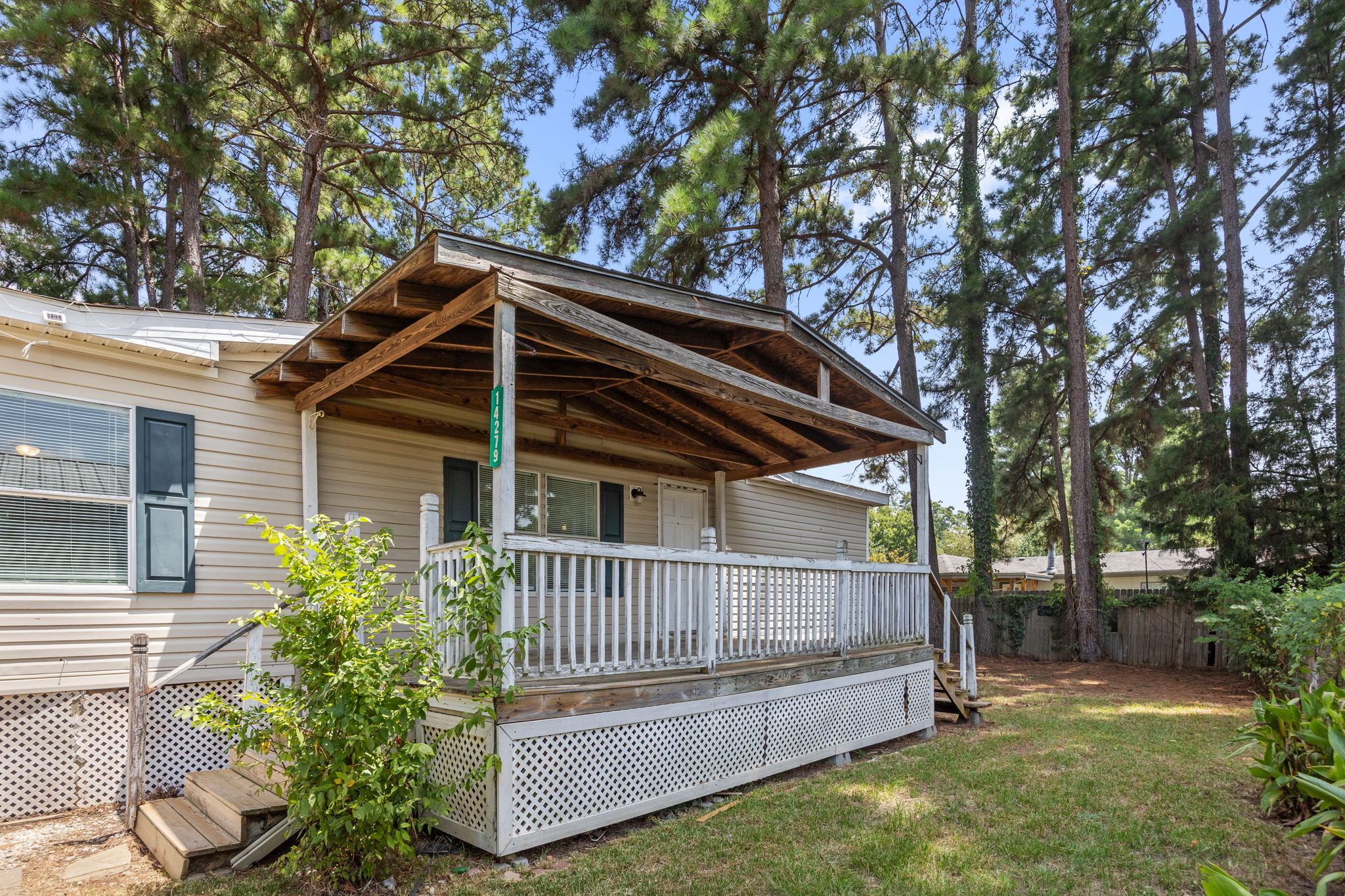Covered front porch at the entry. 14279 Shadow Bay Dr, Willis TX