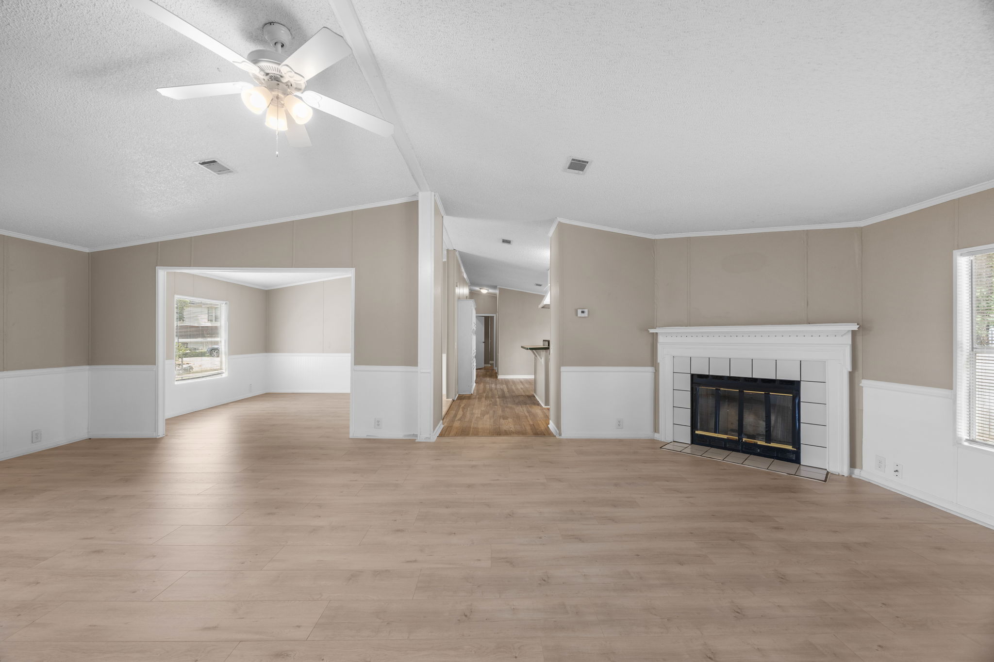 Living room with corner wood burning fireplace and ceiling fan. 14279 Shadow Bay Dr, Willis TX