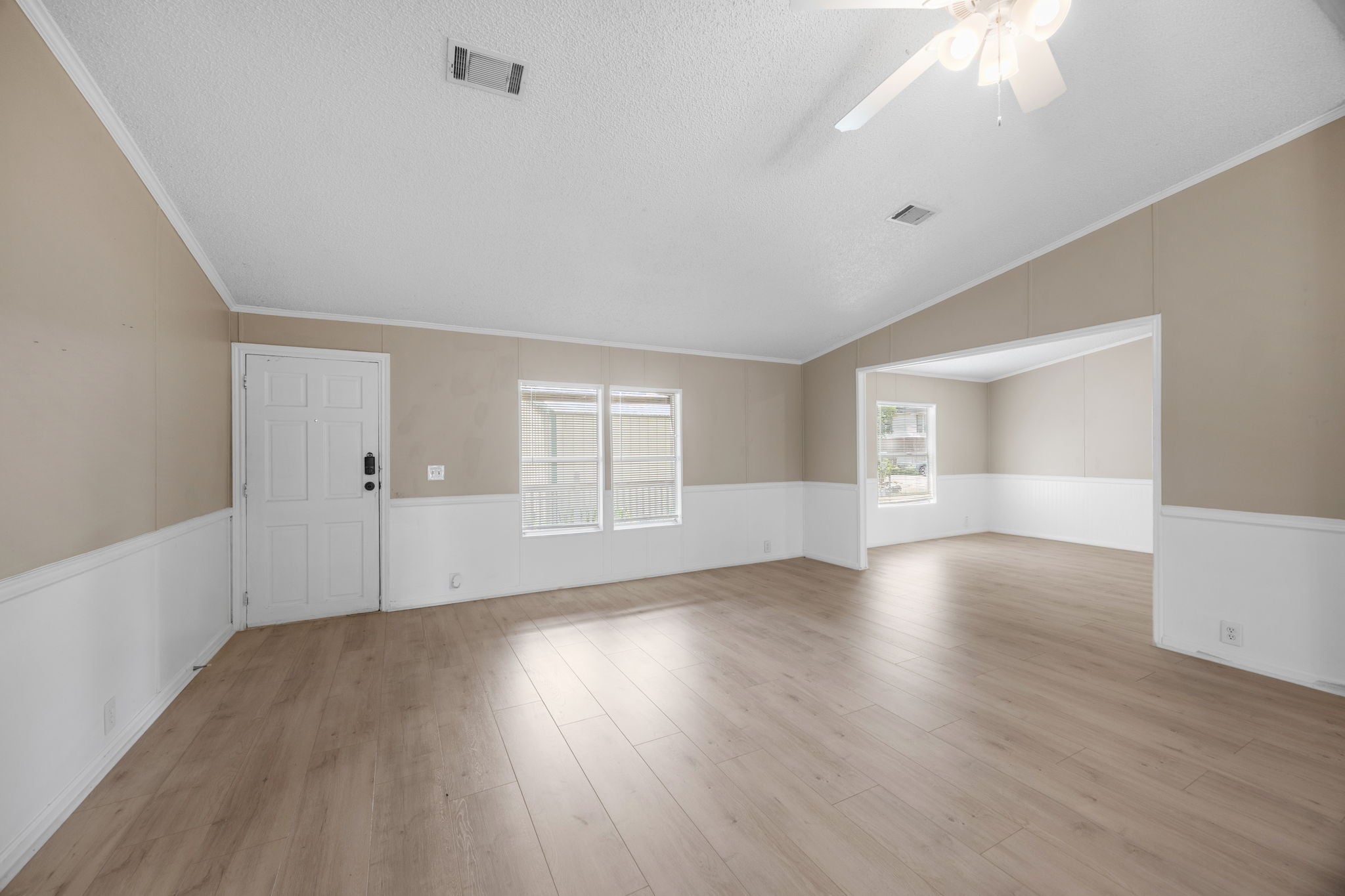 Living room with vaulted ceiling and crown molding. 14279 Shadow Bay Dr, Willis TX