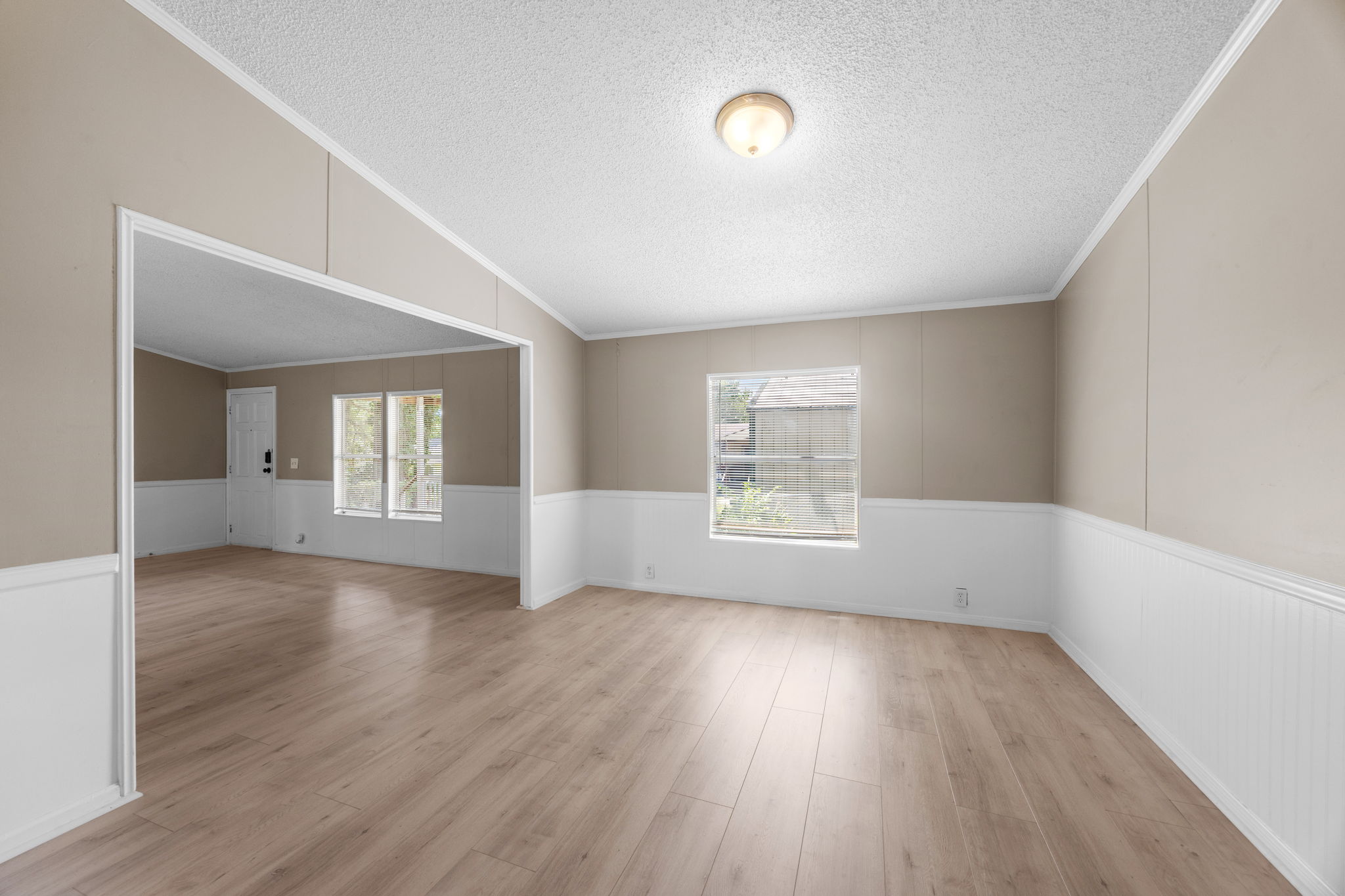 Open living and dining with vaulted ceiling and crown molding. 14279 Shadow Bay Dr, Willis TX