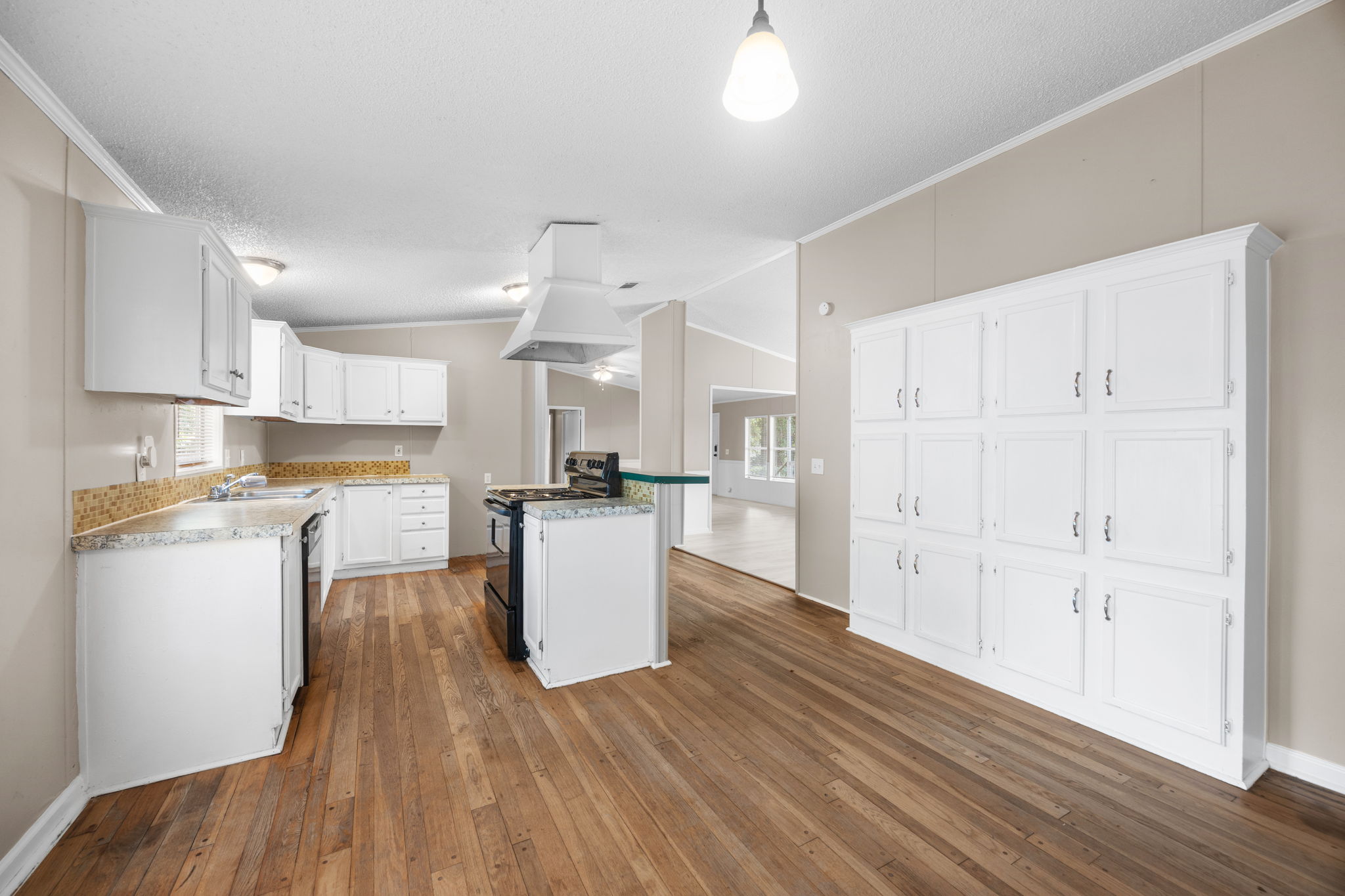 Kitchen with white cabinets and pantry. 14279 Shadow Bay Dr, Willis TX