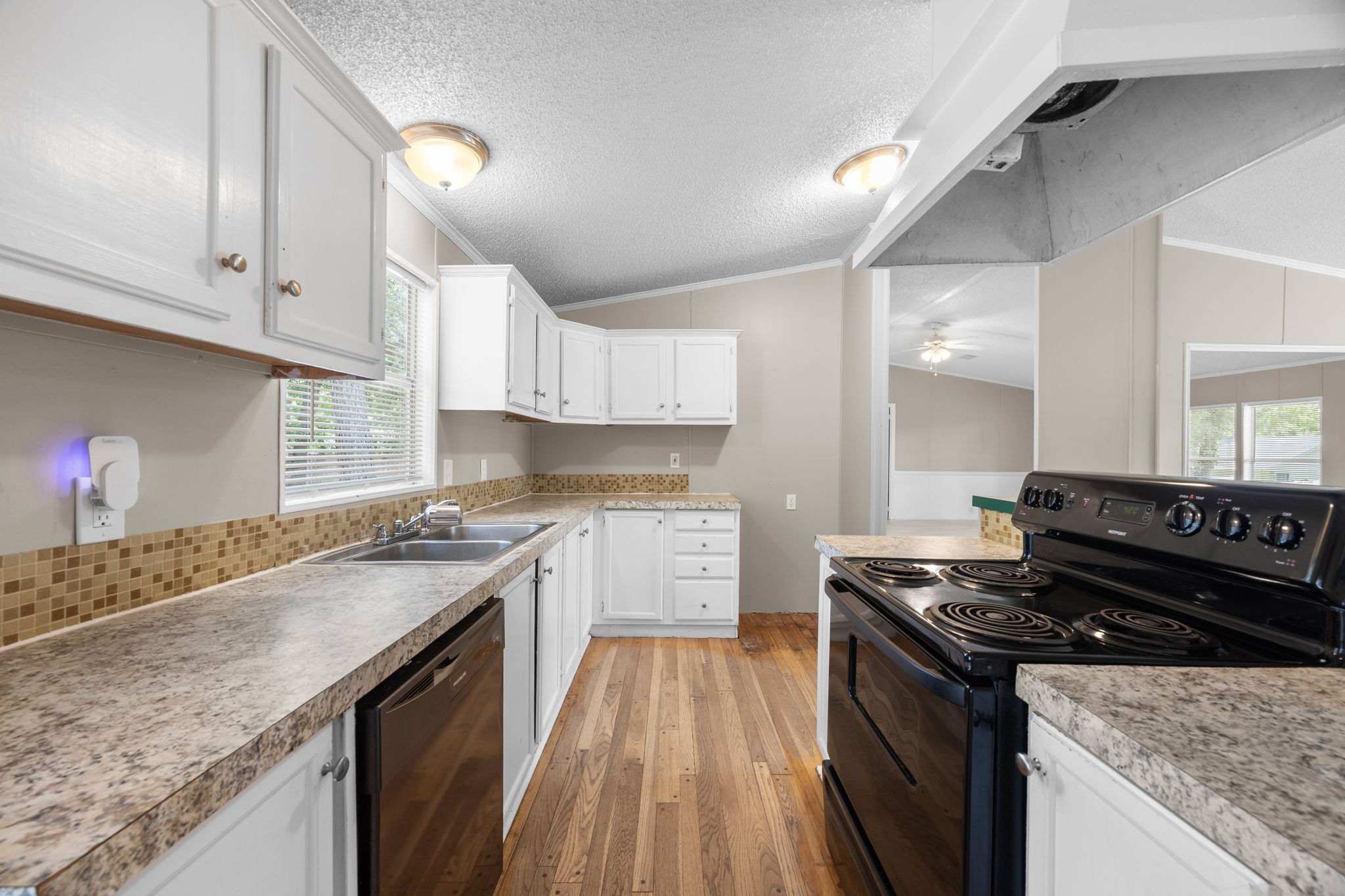 Kitchen counters with freestanding electric range and laminate countertops. 14279 Shadow Bay Dr, Willis TX
