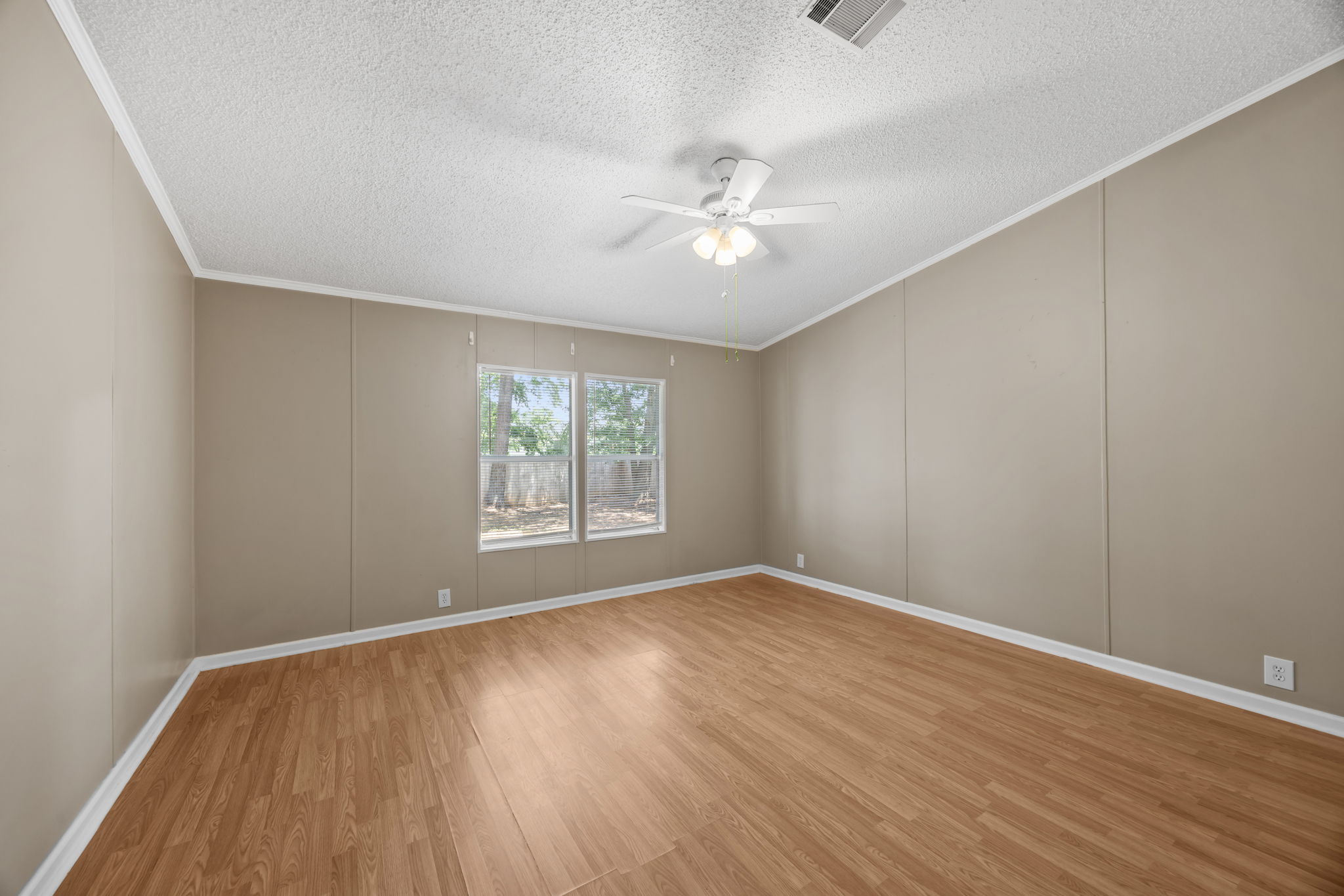 Primary bedroom with ceiling fan and window. 14279 Shadow Bay Dr, Willis TX