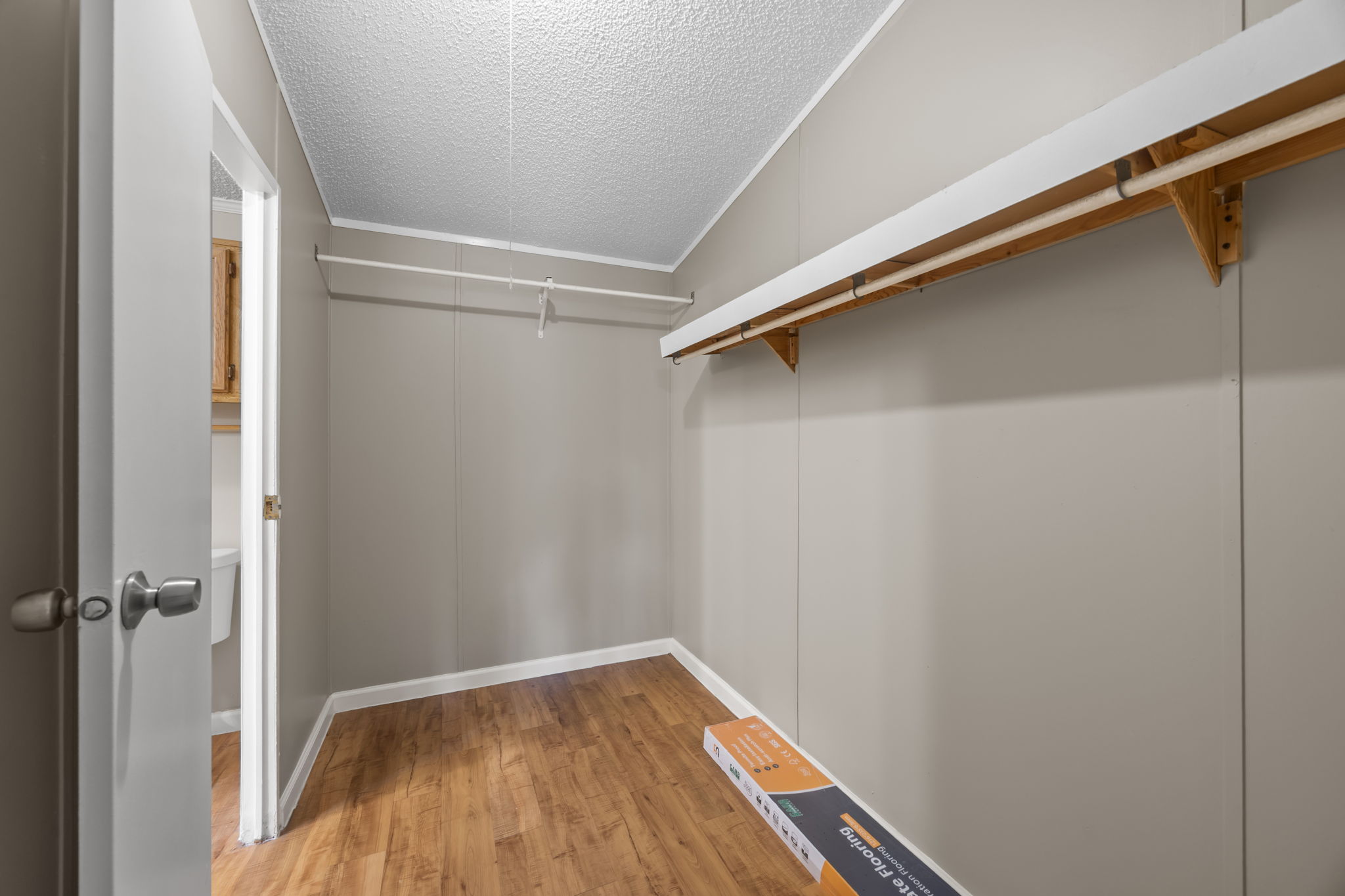 Primary walk in closet with shelf and hanging rod. 14279 Shadow Bay Dr, Willis TX