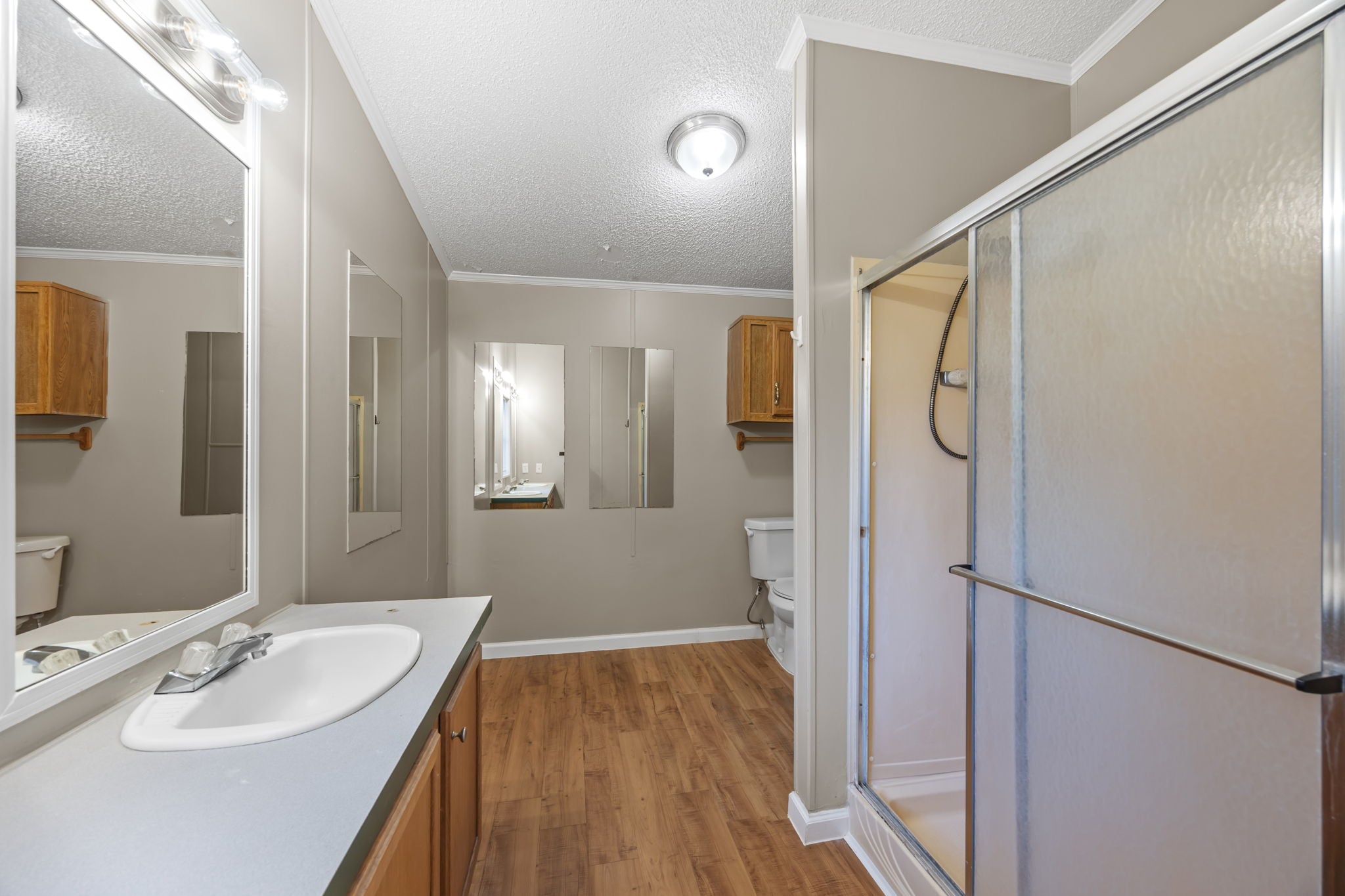 Primary bath vanity and walk in shower. 14279 Shadow Bay Dr, Willis TX