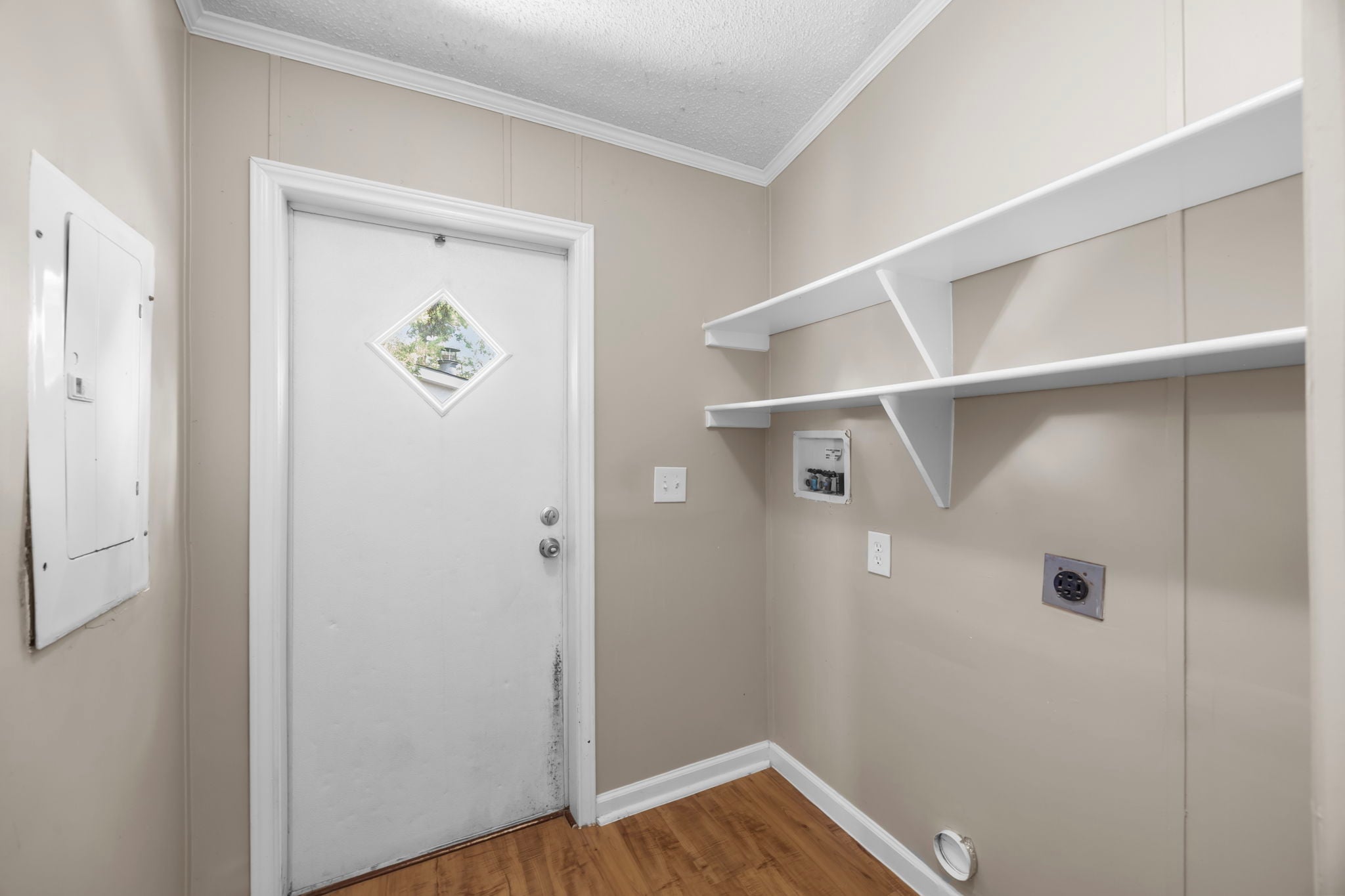 Utility room with built in shelving. 14279 Shadow Bay Dr, Willis TX