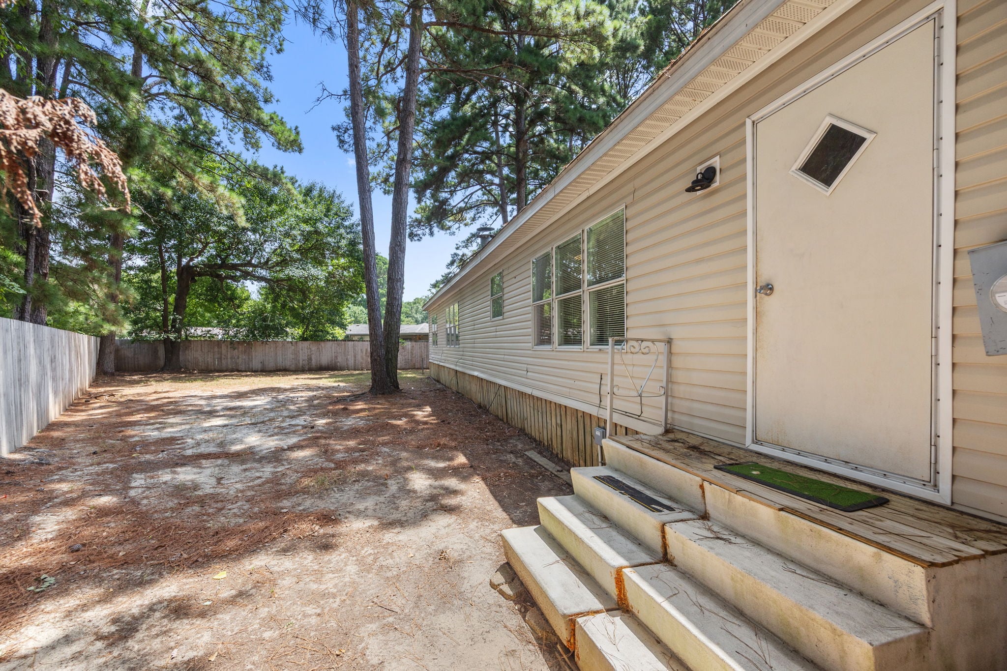 Side of the home at the rear entry. 14279 Shadow Bay Dr, Willis TX