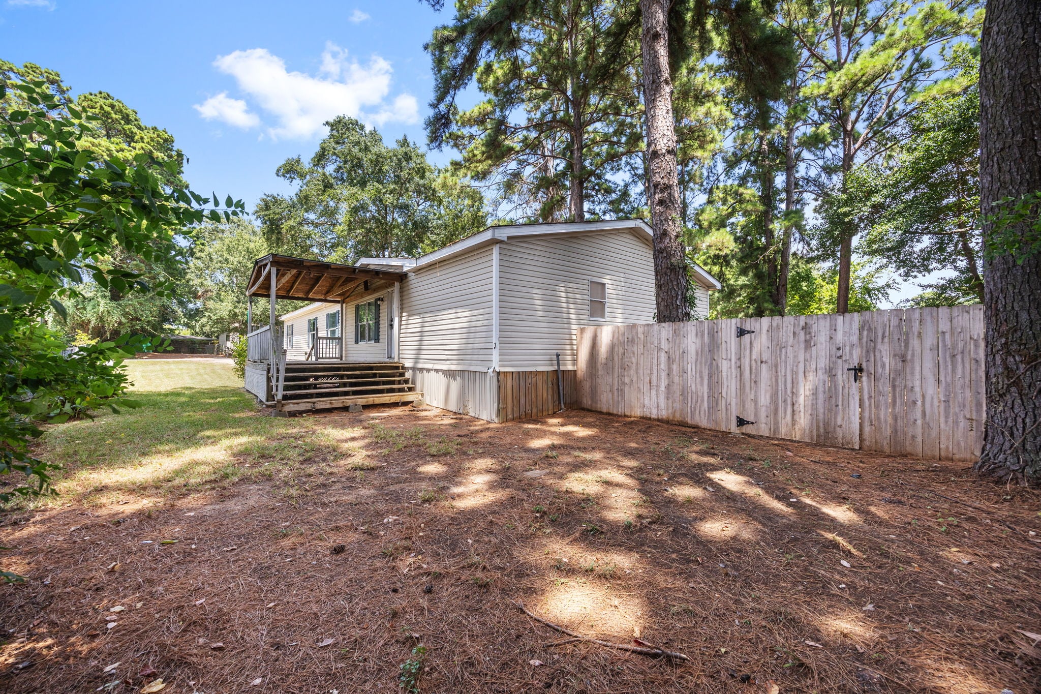 Fenced backyard with wood privacy fence. 14279 Shadow Bay Dr, Willis TX