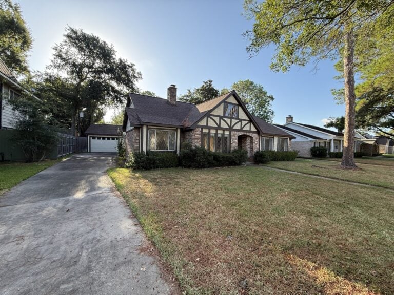 2830 Shadowdale Dr Houston TX front yard and driveway leading to detached two-car garage