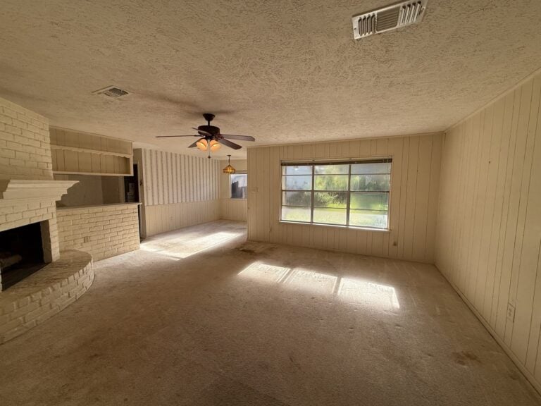 2830 Shadowdale Dr Houston TX family room with brick fireplace and ceiling fan