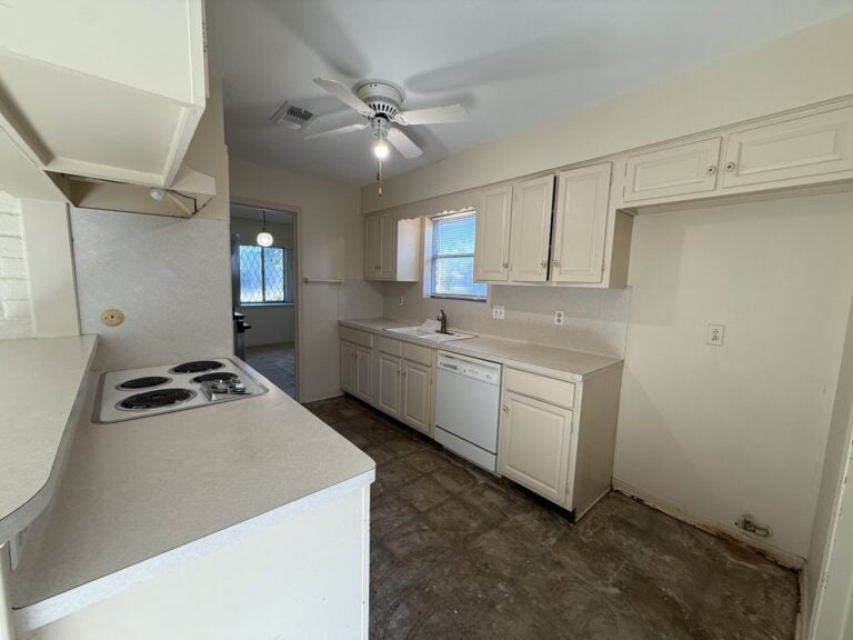 2830 Shadowdale Dr Houston TX kitchen with electric cooktop and white cabinetry