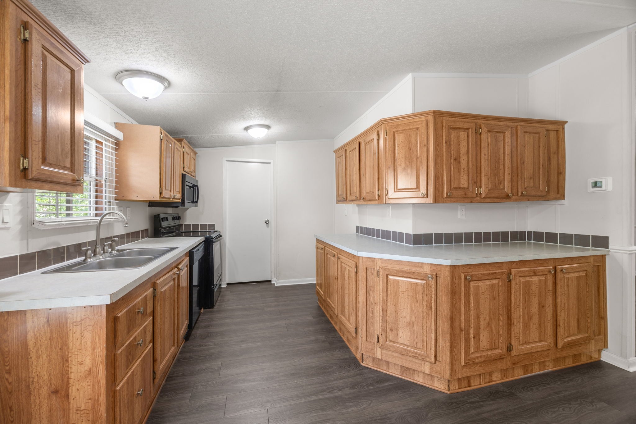 9642 Live Oak Trl Willis TX - Kitchen with smooth-top range and tiled backsplash